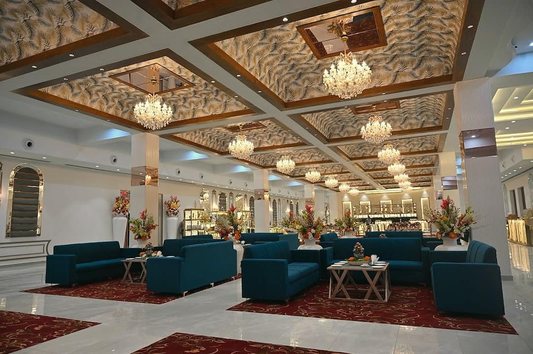 A wide view of the banquet hall's carved ceiling and chandeliers