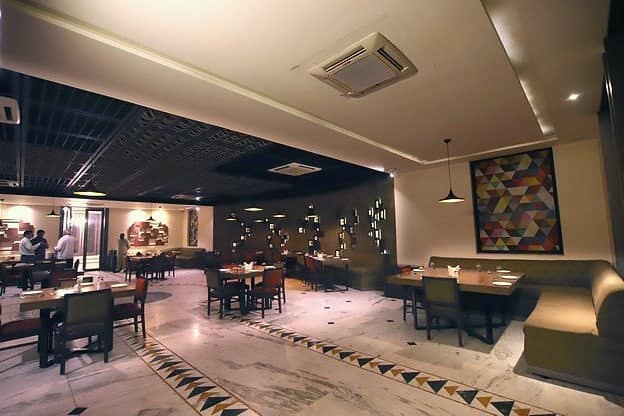 Diners at tables in the AROMA restaurant