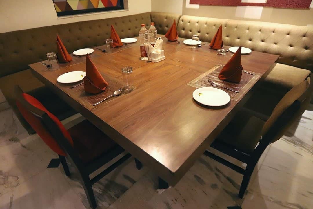 A table laid for dinner with red napkins and white plates