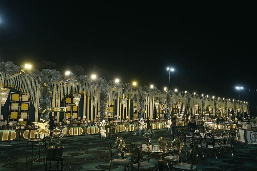 A wide view of a decorated lawn ready for a wedding reception