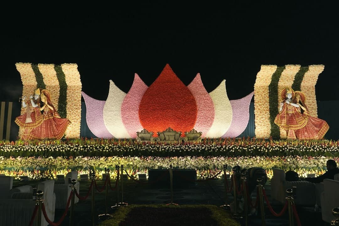 A wedding stage shaped like a giant lotus, with dancers performing in front