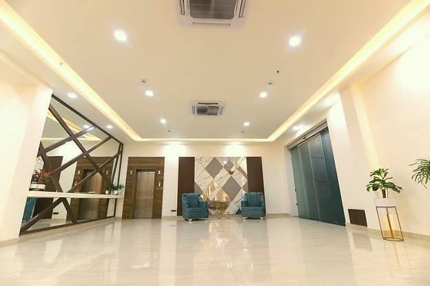 The bright marble lobby with armchairs