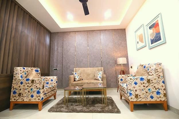 A sitting area with floral armchairs and a small table
