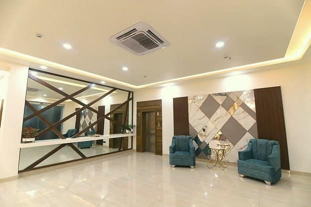 A marble lobby with a geometric feature wall